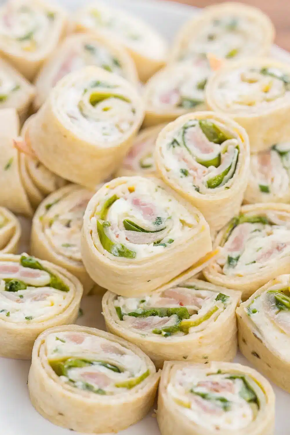 Crisp and creamy dill pickle pinwheels rolled to perfection for a flavorful snack.