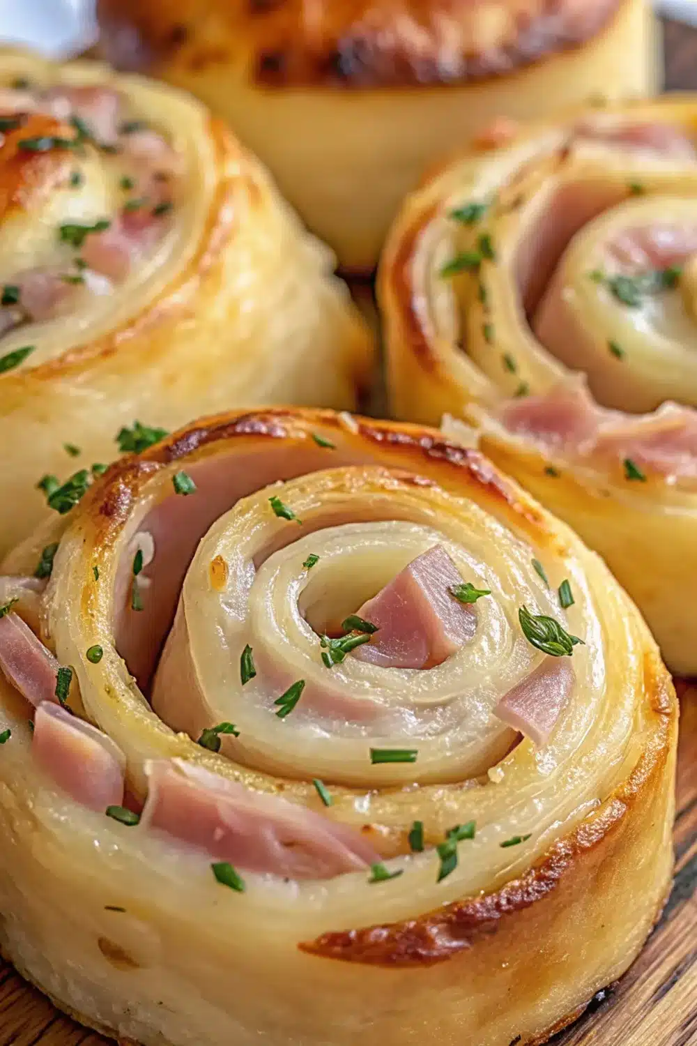 Golden and flaky hot ham and cheese pinwheels fresh from the oven.