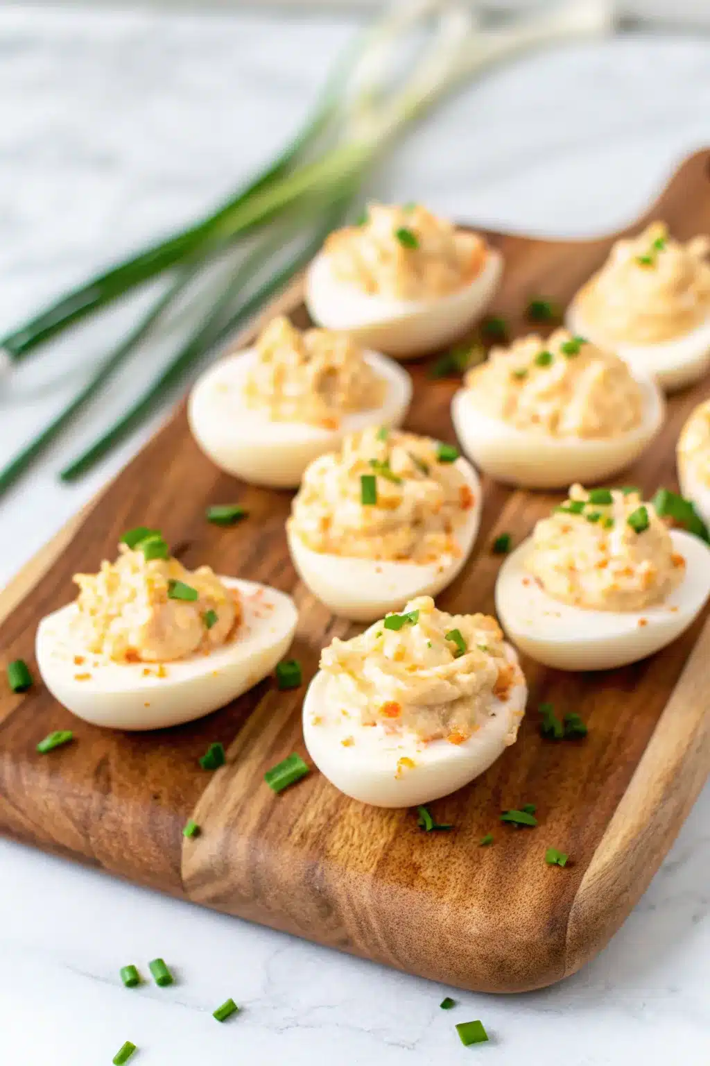 Crab Deviled Eggs garnished with fresh dill and a sprinkle of Old Bay seasoning.